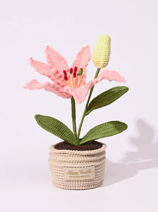 Handmade crochet pink lily flower in a beige pot with green leaves and bud