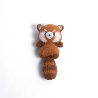 Handmade amigurumi red panda crochet bag charm with fluffy tail on white background